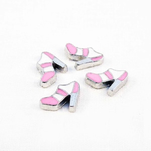 May include: Four silver charm pendants shaped like high-heeled shoes with pink and white enamel details.