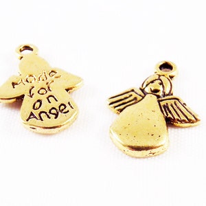 May include: Two gold angel charms. One charm has the words "Made for an Angel" inscribed on it.
