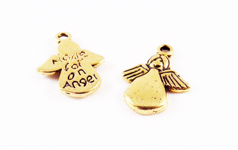 May include: Two gold angel charms. One charm has the words "Made for an Angel" inscribed on it.