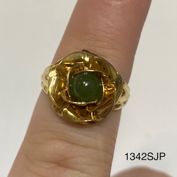 Gold colored ring with large rose shaped flower with a jade colored stone in center