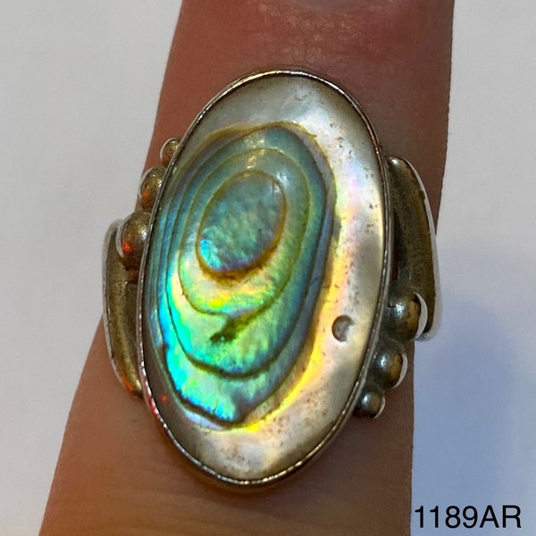 Silver colored ring with large oval abalone colored stone