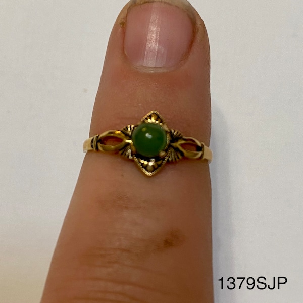 Smaller gold colored ring with small round jade colored stone