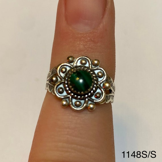 Silver colored ring with small green striped stone