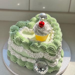 Fake vintage heart cake with disco balls and cupcake