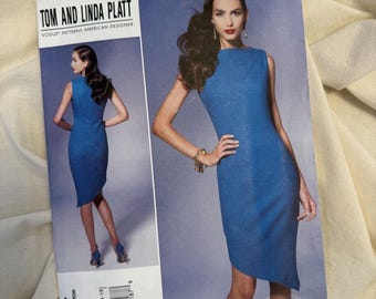 May include: A Vogue Patterns sewing pattern envelope featuring a blue dress design. The envelope includes a photo of a woman wearing the dress, with the text "TOM AND LINDA PLATT" and "V1267" visible.