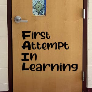 May include: A wooden door with a black vinyl decal that reads "FAIL: First Attempt In Learning".