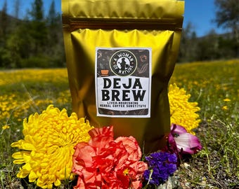 May include: A gold foil pouch of "Deja Brew" herbal coffee substitute, with a label featuring the text "A Woman of Nature." The pouch is surrounded by yellow, red, and purple flowers, set against a backdrop of a field of yellow flowers and a blue sky.