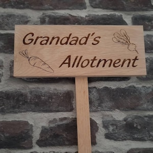 May include: A wooden sign with the text "Grandad's Allotment" engraved on it. The sign is decorated with a carrot and a turnip.