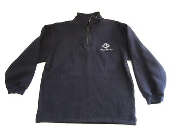 May include: A navy blue long-sleeve sweatshirt with a quarter-zip collar. The sweatshirt features a small white logo on the upper left chest. The logo is a diamond shape with the words "Eddie Bauer" underneath.