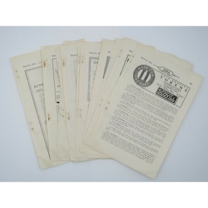 May include: A stack of vintage paper documents with the text "GOOD FOR ONE FARE" and "AERA COIN QUALITY TOKENS" visible. The documents are yellowed with age and have a worn, vintage look.