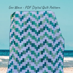 May include: A teal, green, and white quilt pattern with a geometric wave design. The quilt is displayed on a sandy beach with the ocean in the background. Geo Wave - PDF Digital Quilt Pattern.
