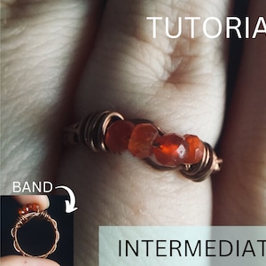 May include: A copper wire wrapped ring with red carnelian stones. The ring is on a finger and the band is shown in a smaller image. The text "TUTORIAL" and "INTERMEDIATE" are visible.