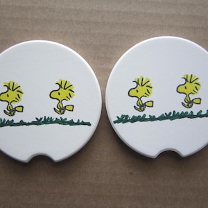 Set of 2 Woodstock car coasters for your cup holders. Featuring the fun loving Peanuts Snoopy bird pal buddy