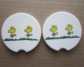 Set of 2 Woodstock car coasters for your cup holders. Featuring the fun loving Peanuts Snoopy bird pal buddy