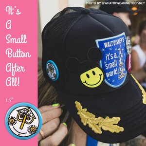 its a small world button trucker hat with mouse ear smiley face patch and vintage small world patch and going to guides walt face pin