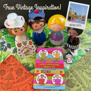 matching buttons with vintage avon perfume bottle it's a small world dolls in mad tea party teacups and matching sticker with art from the golden anniversary bandana like flamingos orange bird mushroom and mr toad hidden mickey