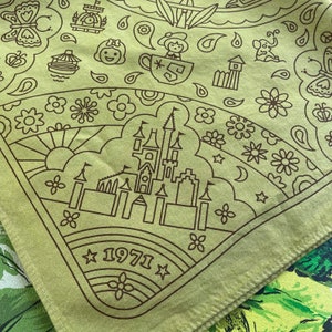 detail of corner  of avocado green option for golden anniversary WDW fandana bandana showing bob around boat snow white top of main street usa building train station avon doll in teacup tom sawyer island fort and jungle cruise elephant castle