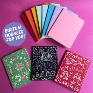 May include: A collection of colorful notebooks, including red, orange, yellow, green, blue, purple, and pink. Several notebooks feature custom doodle designs with names and illustrations. The image includes the text "CUSTOM DOODLES FOR YOU!"