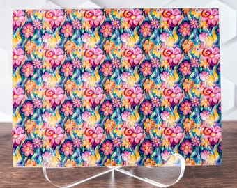 May include: A colorful floral pattern with pink, yellow, and blue flowers on a dark blue background. The pattern is repeated throughout the image.