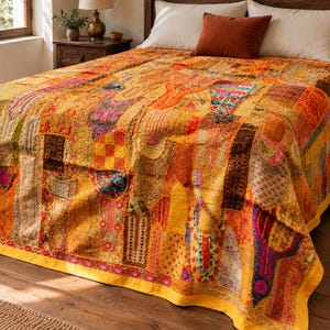 May include: A patchwork bedspread featuring a vibrant array of yellow, orange, and gold fabric panels. The quilt is decorated with intricate embroidery, colorful thread work, and various textile patterns, finished with a solid yellow border.