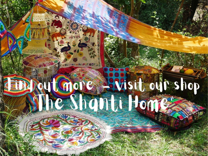 May include: A colorful bohemian-style seating area with patterned cushions, pillows, and a rug. The seating area is set up under a canopy made of a yellow and orange fabric. The text "Find out more - visit our shop 'The Shanti Home'" is visible in the image.
