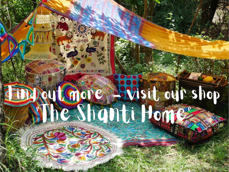 May include: A colourful bohemian-style seating area with cushions, pouffes, and a rug. The area is set up under a canopy of fabric and surrounded by greenery. The text "Find out more - visit our shop 'The Shanti Home'" is visible in the image.