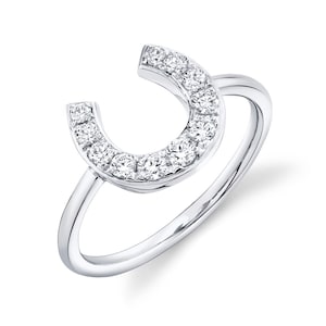 May include: A silver ring with a horseshoe design set with small diamonds.