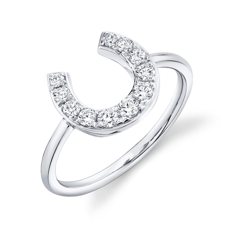 May include: A silver ring with a horseshoe design set with small diamonds.