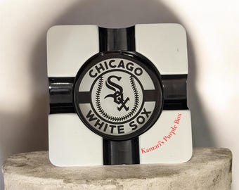 Elevate your next smoke session with this sleek Chicago White Sox Cigar Ashtray. Perfect for game days or relaxing in the man cave.