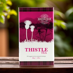 May include: A box of Thistle Tea from the Edinburgh Tea & Coffee Company. The box is pink with a white thistle design and the text "Thistle Tea" in white. The box contains 25 teabags and weighs 1.76 ounces.