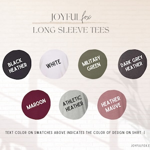 May include: Color swatches for long sleeve tees in black heather, white, military green, dark grey heather, maroon, athletic heather, and heather mauve. Text color on swatches indicates the color of design on shirt.