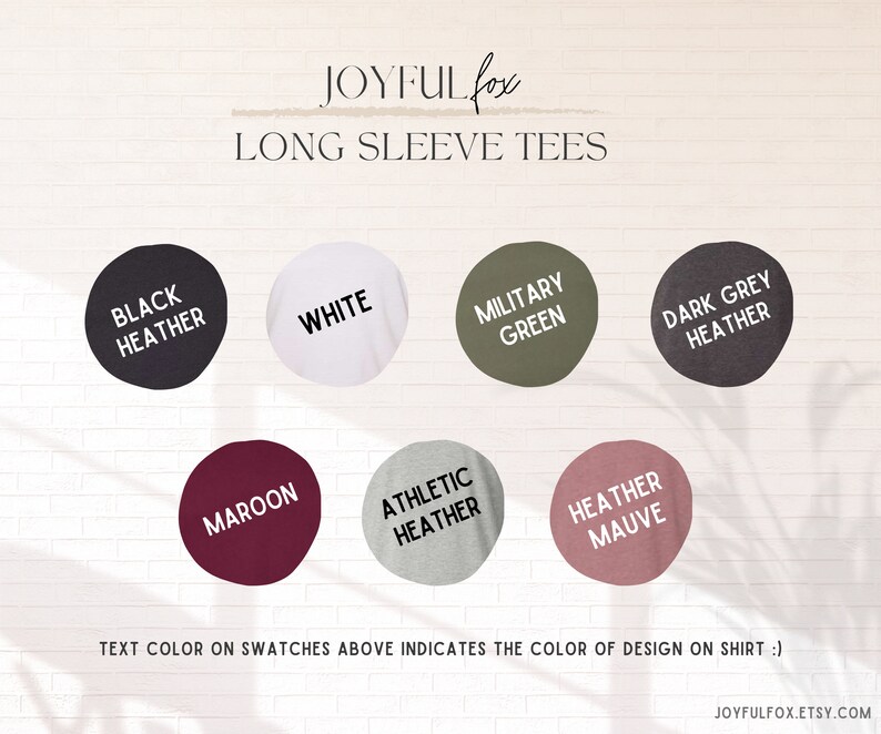 May include: Color swatches for long sleeve tees in black heather, white, military green, dark grey heather, maroon, athletic heather, and heather mauve. Text color on swatches indicates the color of design on shirt.
