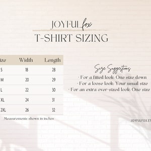May include: T-shirt sizing chart with measurements in inches for sizes S, M, L, XL, and 2XL. The chart includes width and length measurements for each size. Size suggestions are provided for a fitted, loose, or extra over-sized look.