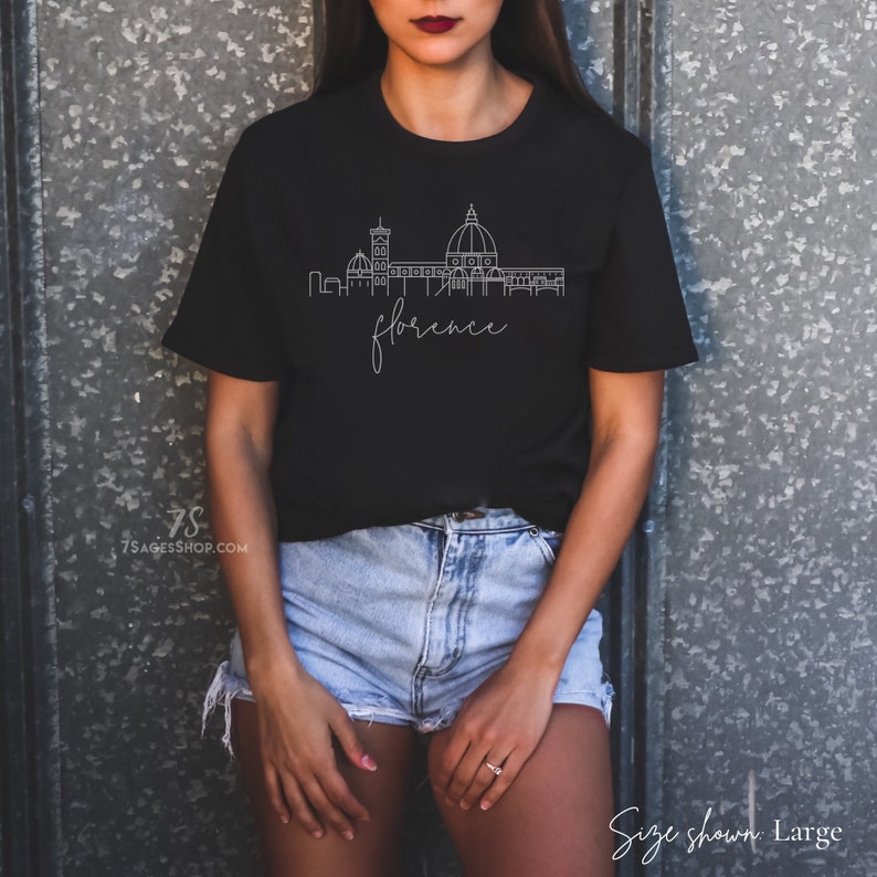 May include: Black t-shirt with a white outline of the Florence skyline and the word "florence" in cursive.