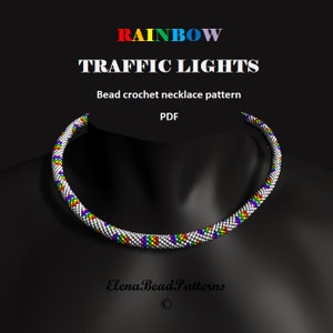 Puede incluir: Patrón de collar de crochet de cuentas: Semáforos arcoíris. El collar es blanco con cuentas de colores arcoíris en un patrón geométrico.
