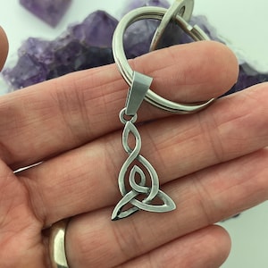 May include: A silver Celtic knot keychain with a key ring. The knot is a traditional symbol of love, friendship, and unity.