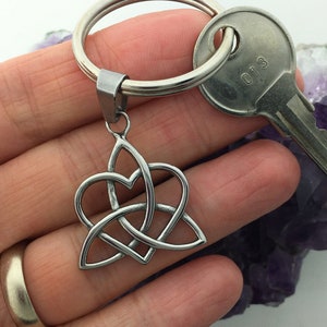 May include: Silver Celtic knot heart keyring with a silver key ring. The knot is a symbol of love, unity, and eternity.