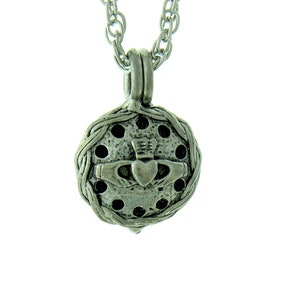 May include: A silver Celtic knot pendant necklace with a round charm featuring a Celtic knot design and a heart. The charm has a textured surface and is surrounded by a circle of small holes.