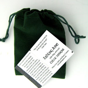 May include: A green velvet pouch with a drawstring closure. The pouch contains a card with the text "Ashling Aine (ash+ling, awn+ye) Celtic Designs Where Love, Spirit, and Beauty Connect. www.ashlingaine.com" and the quote "May the most that you wish for be the least that you get. - Irish Toast"