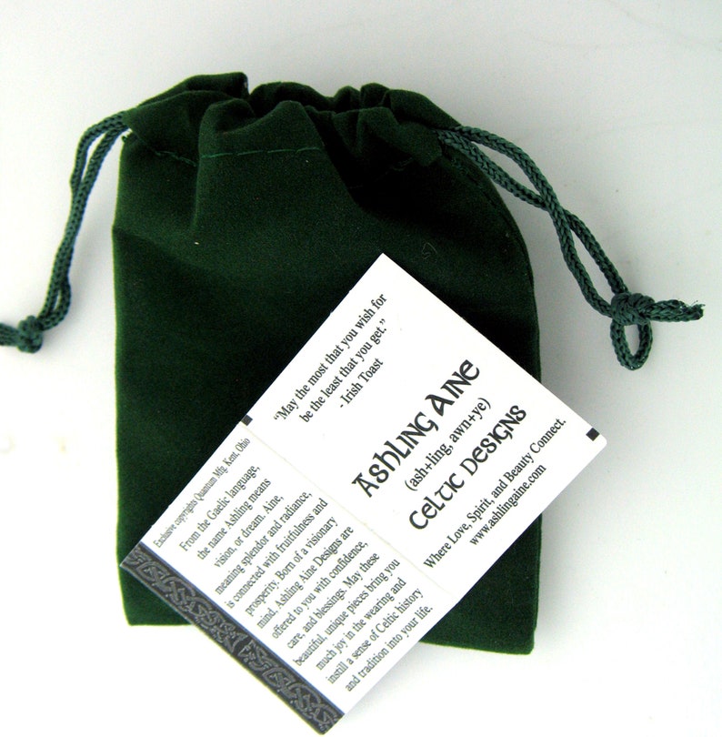 May include: A green velvet pouch with a drawstring closure. The pouch contains a card with the text "Ashling Aine (ash+ling, awn+ye) Celtic Designs Where Love, Spirit, and Beauty Connect. www.ashlingaine.com" and the quote "May the most that you wish for be the least that you get. - Irish Toast"