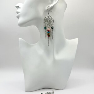 May include: Silver dreamcatcher earrings with colorful beads and feathers.