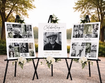 May include: Three black easels display memorial signs. The center sign reads "Celebrating the Life of Oliver Bennett" with a photo and dates. The other signs say "Forever Loved" and "Never Forgotten" with photo collages. White floral arrangements adorn the easels.