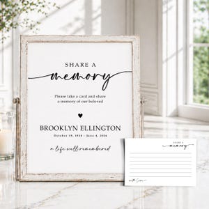 May include: A white sign in a distressed wooden frame with black text reading SHARE A MEMORY, Please take a card and share a memory of our beloved, BROOKLYN ELLINGTON, October 19, 1938 - June 4, 2026, a life well remembered, and a small card.