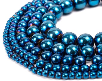 May include: A strand of iridescent blue hematite beads in various sizes. The beads are round and have a smooth, polished finish.