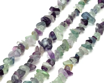 May include: A strand of multi-colored fluorite chip beads. The beads are a mix of green, purple, and blue.
