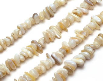 Puede incluir: Una hebra de cuentas de concha blancas y crema, con un acabado nacarado. Las cuentas son de forma irregular y tienen un aspecto natural y orgánico.