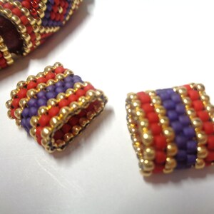 May include: Two close-up images of beaded end caps for a bracelet. The end caps are made of small, colorful beads in shades of red, purple, and gold. The beads are arranged in a repeating pattern of stripes.