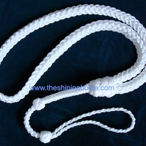 May include: A white braided rope lanyard with a loop and a decorative knot. The lanyard is made of a thick, durable material and is designed to be worn around the neck. The website address www.theshipinabottle.com is visible.
