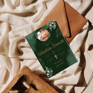 May include: Green baptism invitation with gold lettering. The invitation features a photo of a baby boy in a circle with green foliage around it. The text reads "Please join us for the Baptism of Sebastian Bennett, Saturday, March 25, at 10:00 AM, [address], RSVP to [email address], We appreciate your presence."