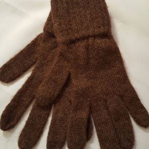 May include: A pair of brown knitted gloves with a ribbed cuff.